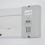 Electrical meter and fuse box on a white wall in Cape Town, South Africa, for energy monitoring or billing.