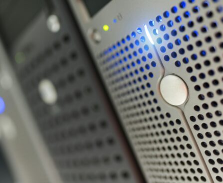 Focused detail of a modern server rack with blue LED indicators in a data center.