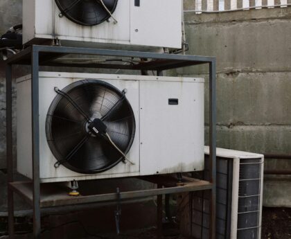 Industrial air conditioning unit stacked outdoors with metallic structure.