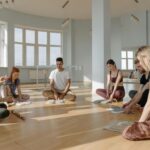 A diverse group of people meditating together indoors, creating a serene and peaceful environment.